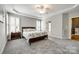 Serene bedroom featuring tray ceiling, plantation shutters, carpet, and neutral paint at 208 Mcduffie Ln, Fort Mill, SC 29715