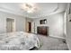 Large bedroom with tray ceiling, carpet, plantation shutters, and a dark wood dresser at 208 Mcduffie Ln, Fort Mill, SC 29715