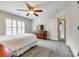 Cozy bedroom featuring natural light, carpet floors, a ceiling fan, and wooden dresser at 208 Mcduffie Ln, Fort Mill, SC 29715