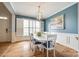 Dining room with large windows, white table, blue chairs and stylish light fixture at 208 Mcduffie Ln, Fort Mill, SC 29715