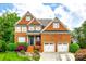 Beautiful two-story brick home with attached two-car garage and manicured landscaping at 208 Mcduffie Ln, Fort Mill, SC 29715