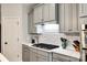 Updated kitchen features stainless appliances, white subway tile backsplash, and stylish gray cabinetry at 208 Mcduffie Ln, Fort Mill, SC 29715