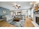 Open-concept living room featuring hardwood floors, fireplace, and neutral furniture throughout at 208 Mcduffie Ln, Fort Mill, SC 29715