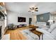 Spacious living room featuring fireplace, modern furniture, ceiling fan, and hardwood floors at 208 Mcduffie Ln, Fort Mill, SC 29715