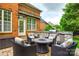 A charming brick patio featuring an outdoor grill area, a fire pit, and wicker furniture at 208 Mcduffie Ln, Fort Mill, SC 29715