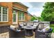 Cozy outdoor patio with comfortable seating, built-in grill, and stone accents, perfect for entertaining at 208 Mcduffie Ln, Fort Mill, SC 29715