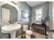 Stylish powder room with pedestal sink, neutral wall color and decorative mirror and accents at 208 Mcduffie Ln, Fort Mill, SC 29715