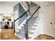 Staircase with gray carpet runner, black handrail, and white risers at 208 Mcduffie Ln, Fort Mill, SC 29715