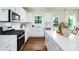 Bright kitchen featuring white cabinets, stainless steel appliances, and a view to the backyard at 227 Paige Rd, Kings Mountain, NC 28086