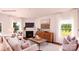 Bright living room with a fireplace, neutral furniture, and large windows at 227 Paige Rd, Kings Mountain, NC 28086