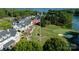 Aerial view of a golf course and lake community with a prominent American flag at 2288 Brawley School Rd, Mooresville, NC 28117