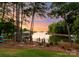 Backyard with a dock and lake views through the trees at 2288 Brawley School Rd, Mooresville, NC 28117