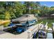 Covered boat on lift at private dock on a wooded lot with lake views at 2288 Brawley School Rd, Mooresville, NC 28117