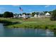 Scenic view of golf course and lake with clubhouse in the background at 2288 Brawley School Rd, Mooresville, NC 28117