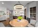 Open dining area with view of kitchen showcases a chandelier and natural light from a window at 2288 Brawley School Rd, Mooresville, NC 28117
