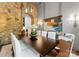 Stylish dining room features a stone wall, modern lighting, and a dark wood table with seating for six at 2288 Brawley School Rd, Mooresville, NC 28117