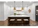 Modern kitchen features white cabinetry, a large island with seating, and stylish pendant lighting at 2288 Brawley School Rd, Mooresville, NC 28117