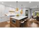 Spacious kitchen showcases a large island with seating, stainless steel appliances, and white cabinets at 2288 Brawley School Rd, Mooresville, NC 28117