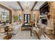 Bright living room with stone fireplace, wooden beams, stylish furnishings, and access to the back patio at 2288 Brawley School Rd, Mooresville, NC 28117
