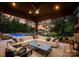 Covered patio with a luxurious outdoor sectional couch, lake views, and a swimming pool at 2288 Brawley School Rd, Mooresville, NC 28117