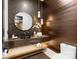 Stylish powder room with wood accent wall, vessel sink, floating vanity and shelf, and pendant lighting at 2288 Brawley School Rd, Mooresville, NC 28117