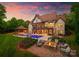 Stunning home boasts a luxurious pool, outdoor kitchen, and cozy fire pit area at 2288 Brawley School Rd, Mooresville, NC 28117