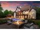 Beautiful home showcases a pool, fire pit, and manicured landscaping at 2288 Brawley School Rd, Mooresville, NC 28117