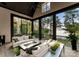 Bright sunroom with floor-to-ceiling windows, comfortable seating, and views of the lake at 2288 Brawley School Rd, Mooresville, NC 28117