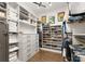 Organized walk-in closet with custom shelving, drawers, and ample storage space for clothes and accessories at 2288 Brawley School Rd, Mooresville, NC 28117