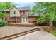 The house features a wooden back deck, brick exterior, and lush greenery around the property at 2330 Raven Dr, Rock Hill, SC 29732
