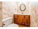 Traditional half bathroom featuring a decorative mirror and floral wallpaper at 2330 Raven Dr, Rock Hill, SC 29732