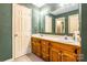 Bathroom featuring double sinks with wooden cabinets and large mirrors at 2330 Raven Dr, Rock Hill, SC 29732