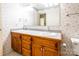 Bathroom boasts double sinks, wooden cabinets, and patterned wallpaper at 2330 Raven Dr, Rock Hill, SC 29732