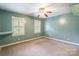 Bedroom with neutral carpet, ceiling fan, and two windows with shutter-style blinds at 2330 Raven Dr, Rock Hill, SC 29732