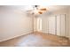 Carpeted bedroom featuring a ceiling fan and double closets for storage at 2330 Raven Dr, Rock Hill, SC 29732