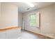 Bedroom with neutral carpet, built-in storage, and window with shutter-style blinds at 2330 Raven Dr, Rock Hill, SC 29732