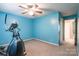 Bright blue bedroom with an exercise machine, ceiling fan, and neutral carpet at 2330 Raven Dr, Rock Hill, SC 29732