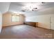 Spacious bonus room featuring built-in storage, neutral carpet, and two ceiling fans at 2330 Raven Dr, Rock Hill, SC 29732