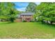 Beautiful two-story brick home with a lush green lawn and mature trees creating a serene setting at 2330 Raven Dr, Rock Hill, SC 29732