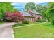 Charming brick home with a well-maintained lawn, complemented by a vibrant Japanese maple near the driveway at 2330 Raven Dr, Rock Hill, SC 29732