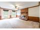 Inviting living room with a brick fireplace, shuttered windows, and classic wood paneling, creating a cozy ambiance at 2330 Raven Dr, Rock Hill, SC 29732