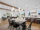 Open concept dining room with a fireplace, hardwood floors, a decorative chandelier, and an attached kitchen at 2370 Bridgewater Rd, Rock Hill, SC 29730