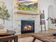 Close-up of a stone fireplace with a wooden mantle, adding warmth and character to the room at 2370 Bridgewater Rd, Rock Hill, SC 29730