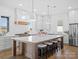 Bright kitchen featuring a large island, modern stools, and stainless refrigerator at 2370 Bridgewater Rd, Rock Hill, SC 29730