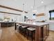 Large kitchen island with bar seating, modern lighting, and a view into the living area with fireplace at 2370 Bridgewater Rd, Rock Hill, SC 29730