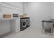 Well-organized laundry room with modern appliances, white cabinets, and ample counter space at 2370 Bridgewater Rd, Rock Hill, SC 29730