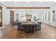 Bright open-concept living space featuring wooden beams, a stone fireplace, and hardwood floors at 2370 Bridgewater Rd, Rock Hill, SC 29730