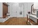 Well-lit mudroom with custom storage, wooden bench, wood-look flooring, and white trim at 2370 Bridgewater Rd, Rock Hill, SC 29730