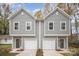 Charming two-story townhome with a two-car garage, neutral siding, and well-manicured landscaping at 2818 Old Steele Creek Rd, Charlotte, NC 28208