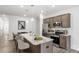 Modern kitchen features a central island with granite countertops, stainless steel appliances, and breakfast bar seating at 2918 Sloan Dr, Charlotte, NC 28208